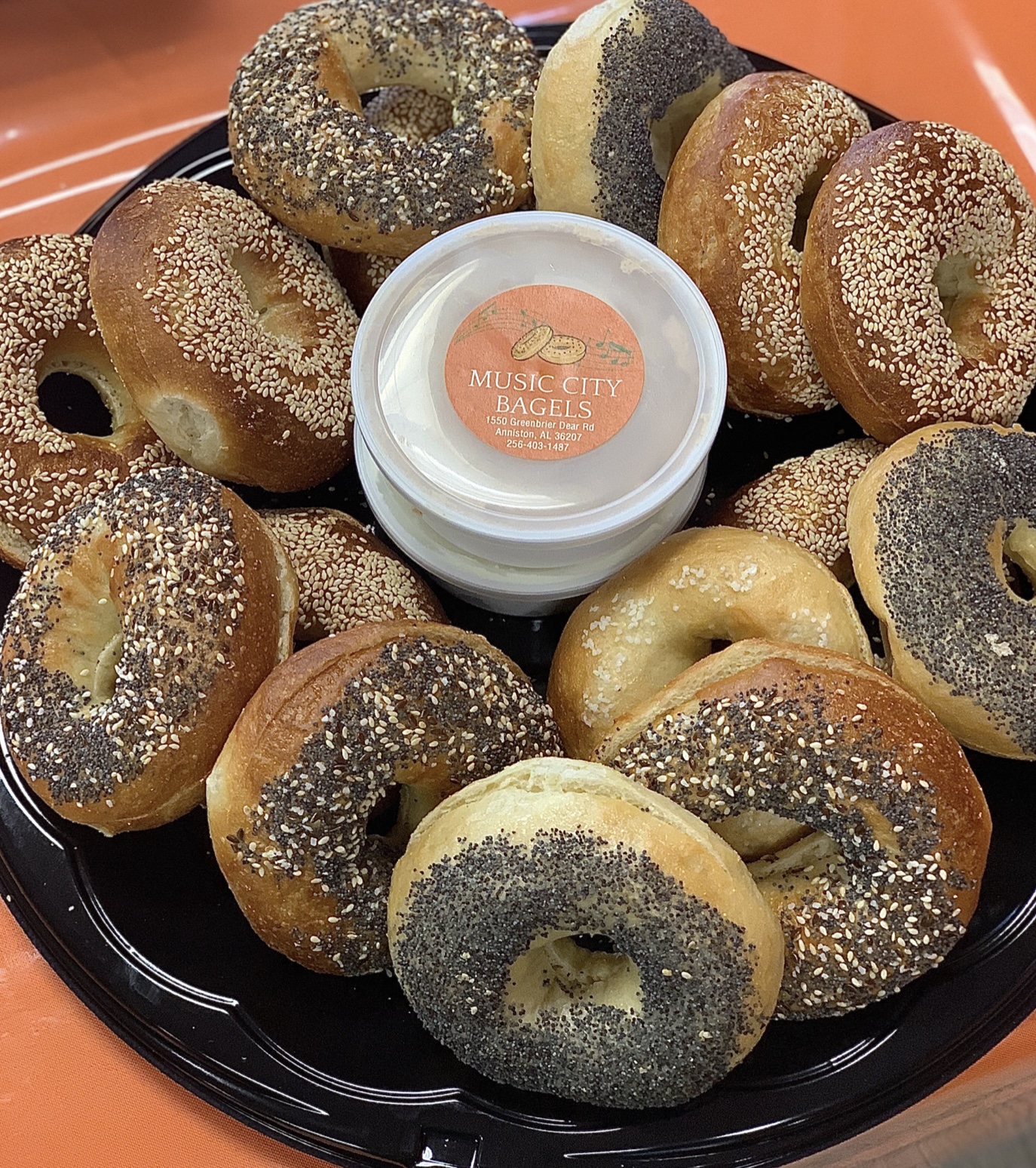 Everything bagel muffaletta sandwich with bacon, egg, and cheese